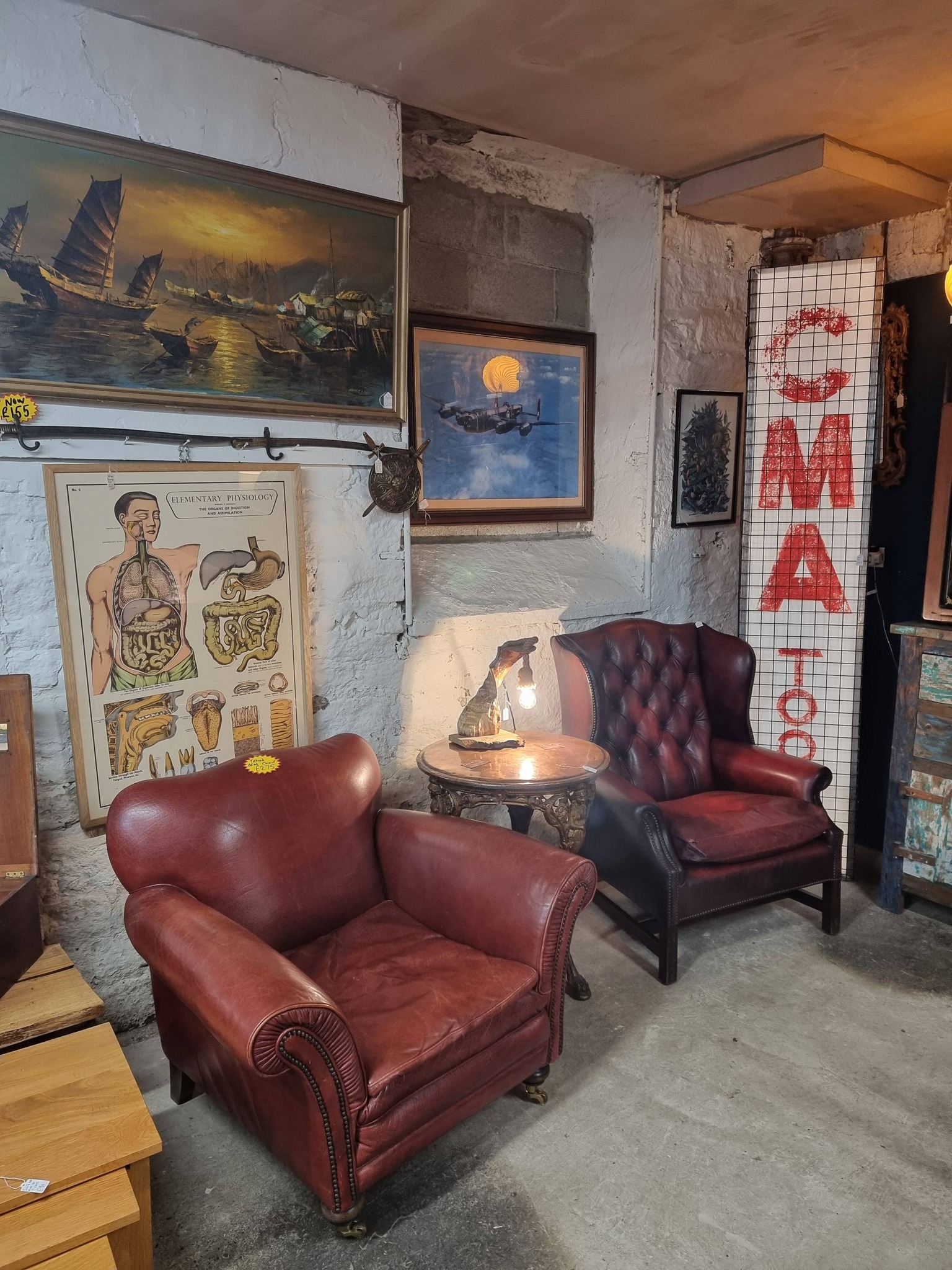 Leather club chairs and vintage artwork inside Chic & Tique